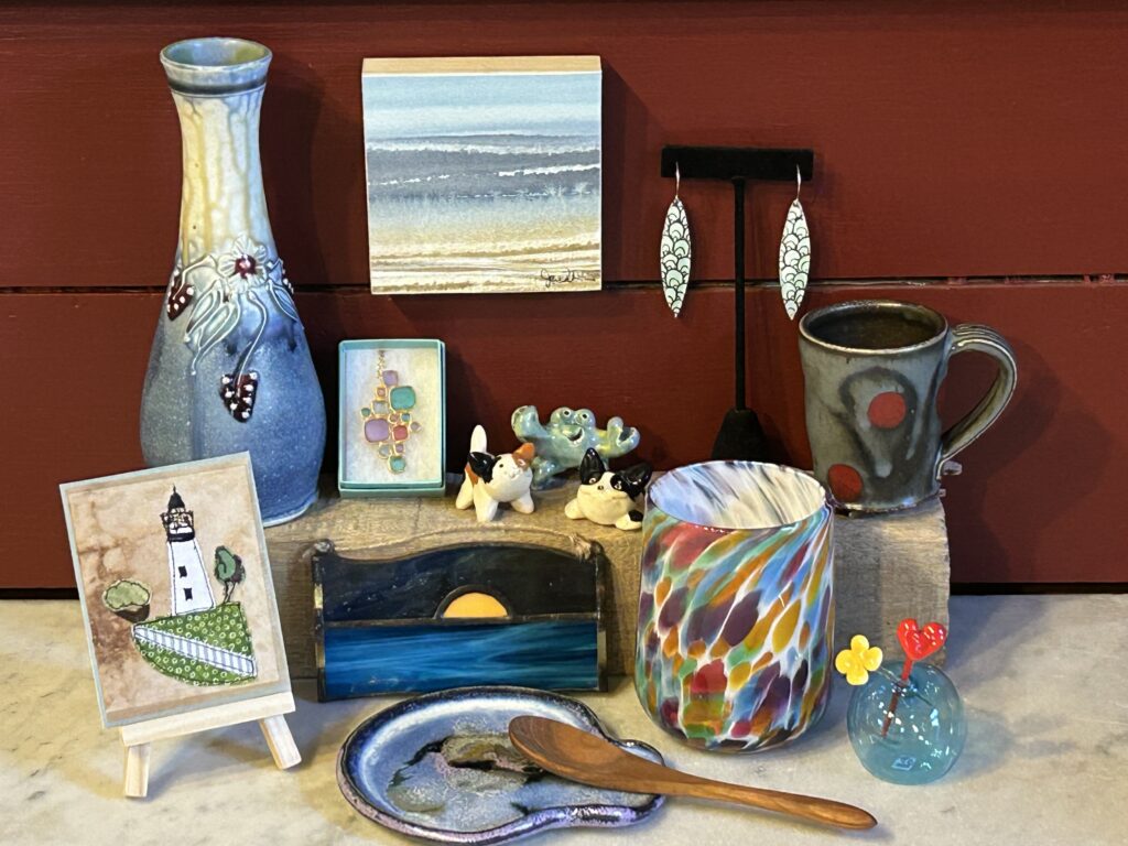 Colorful artisan crafts and pottery display on shelf.