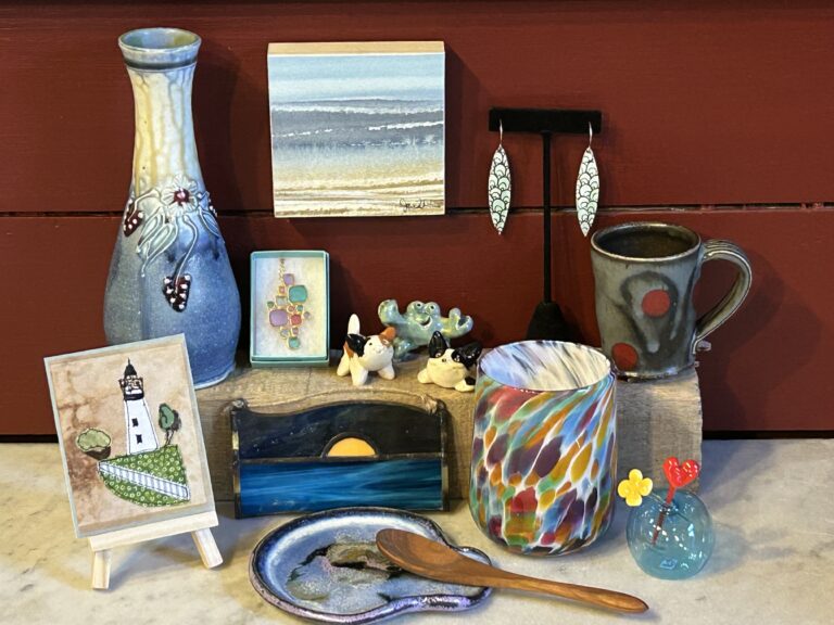 Colorful artisan crafts and pottery display on shelf.