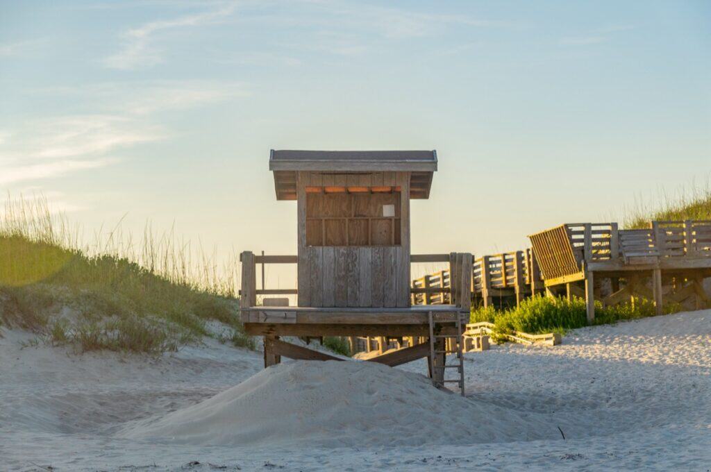 Lifeguard hut on sandy beach at sunset