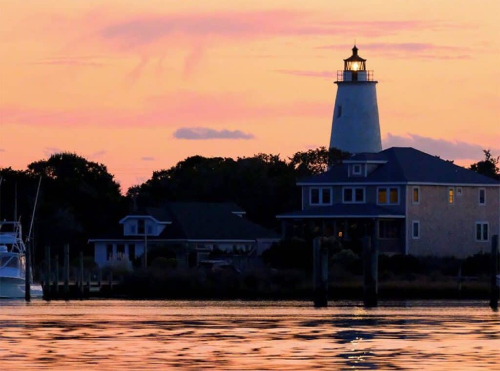 Sunset view of lighthouse by the water