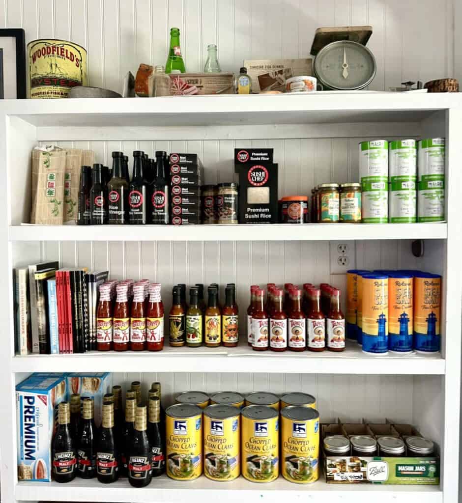 Pantry shelves filled with various canned and bottled goods.