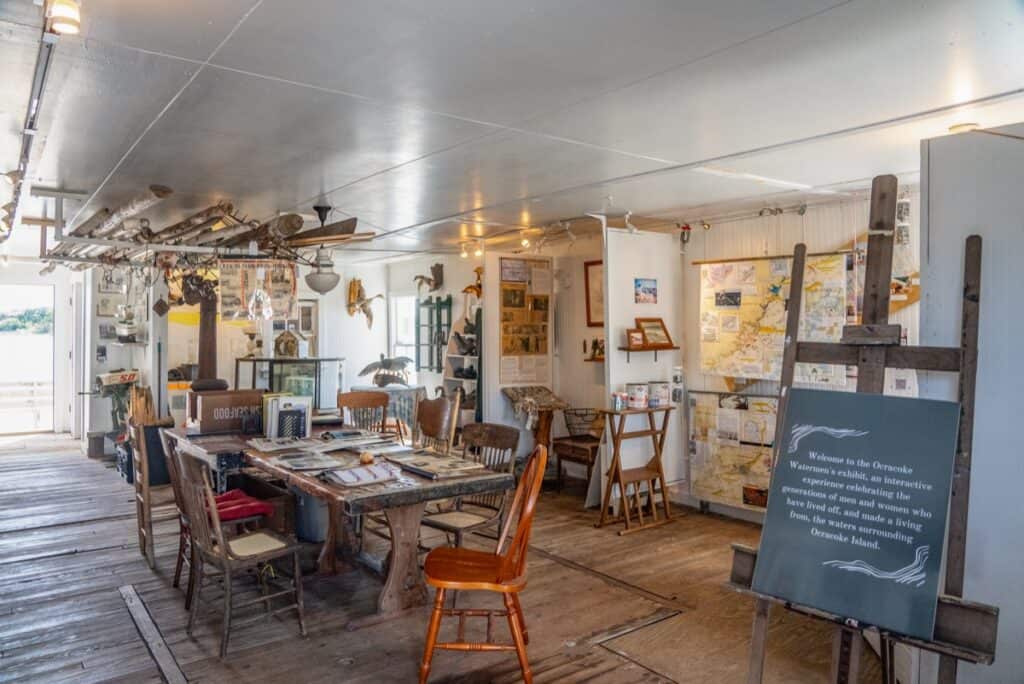 Historical museum exhibit with maps and artifacts.