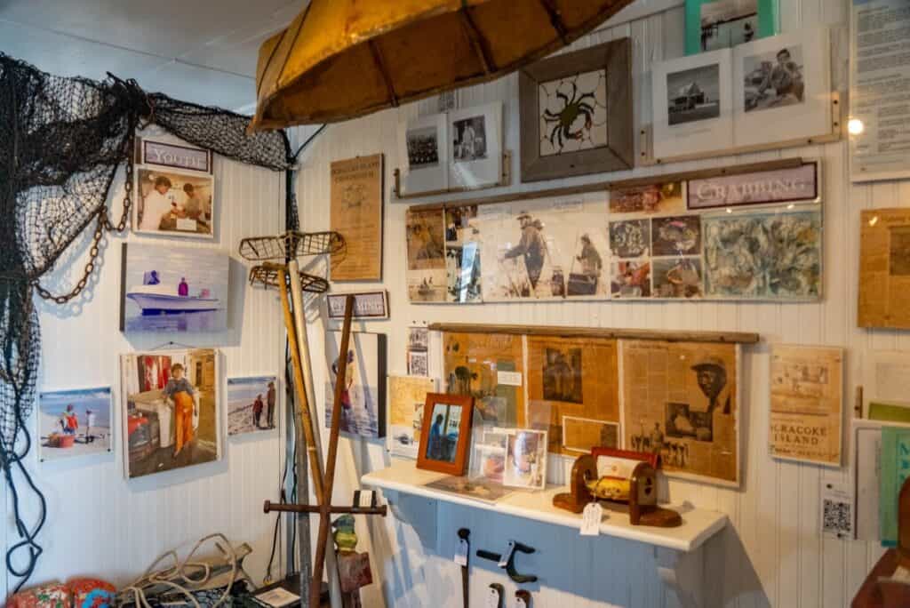 Maritime history exhibit with tools, photos, and nets.