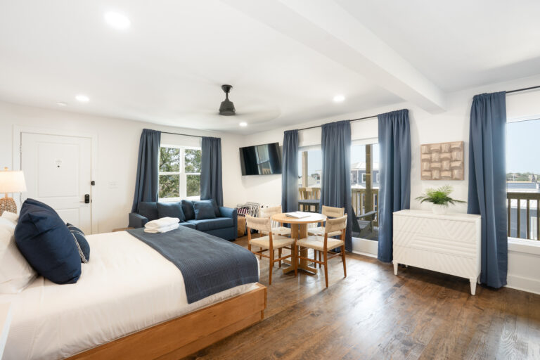 Bright modern studio with bed, sofa, and balcony